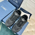 Dior unisex sneakers, dark grey with black laces and side logo, two shoes front view