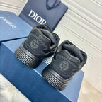 Dior unisex sneakers, dark grey pair with embossed heel logo and striped sole tread view