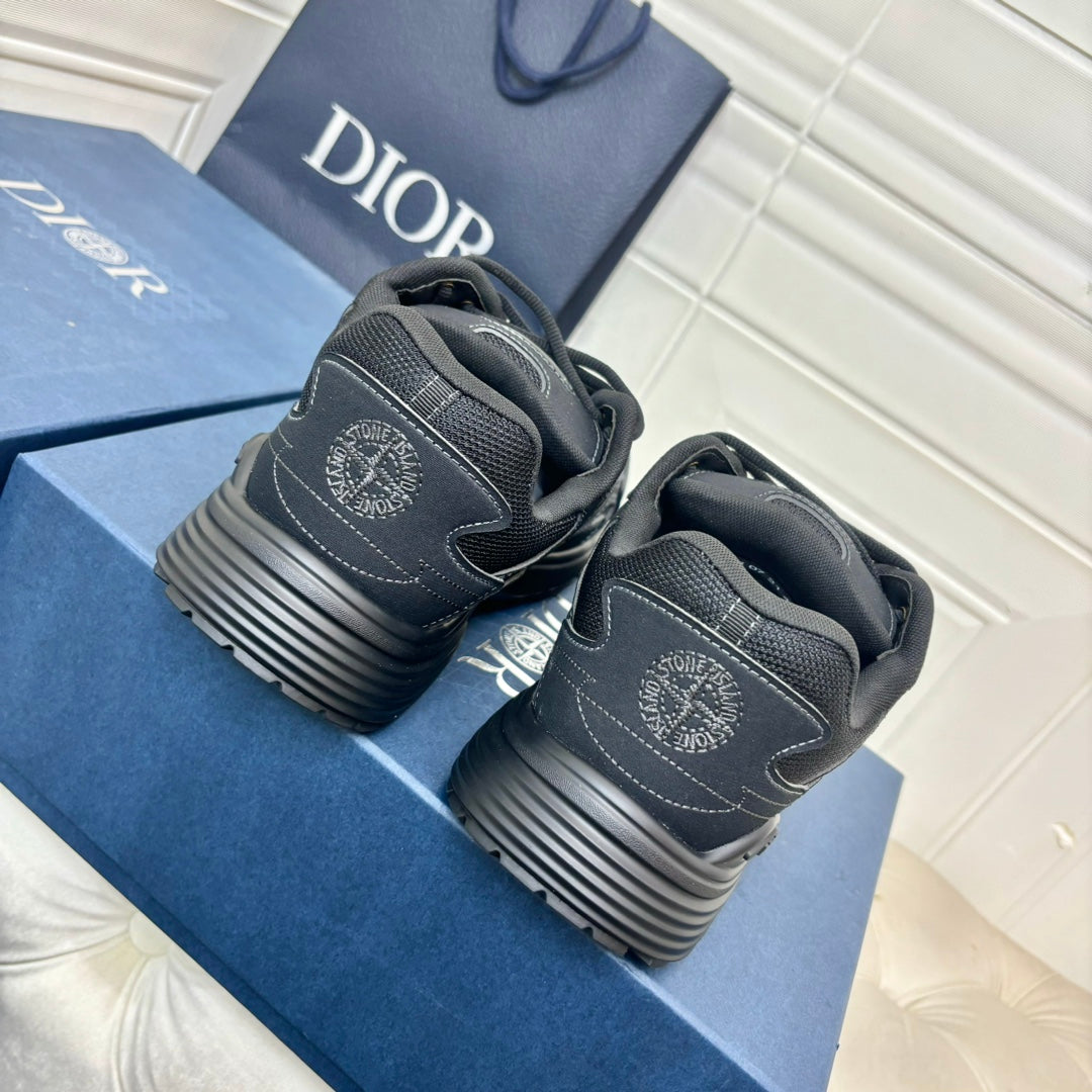 Dior unisex sneakers, dark grey pair with embossed heel logo and striped sole tread view