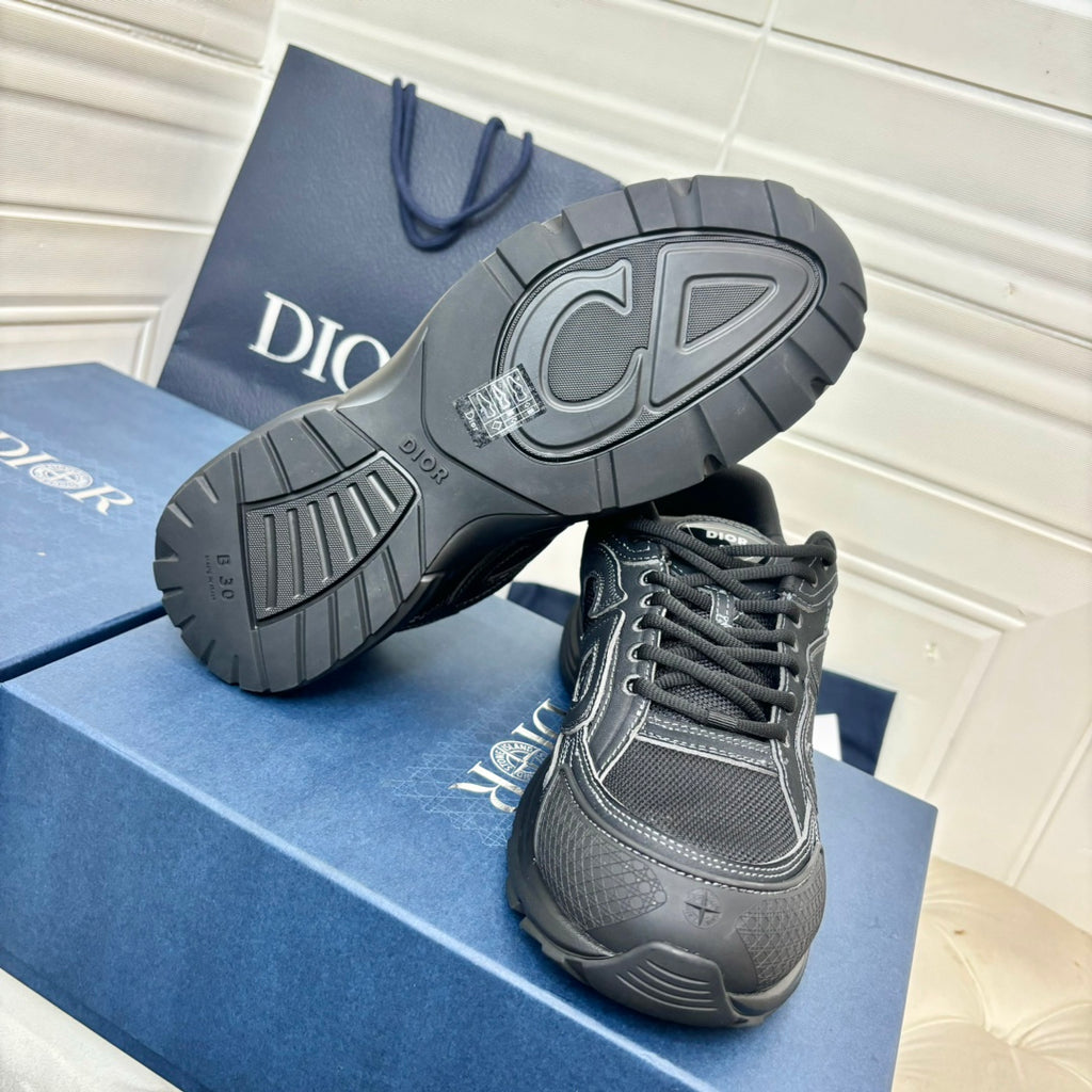 Dior unisex sneakers, dark grey with black tread outsole and side logo, bottom view