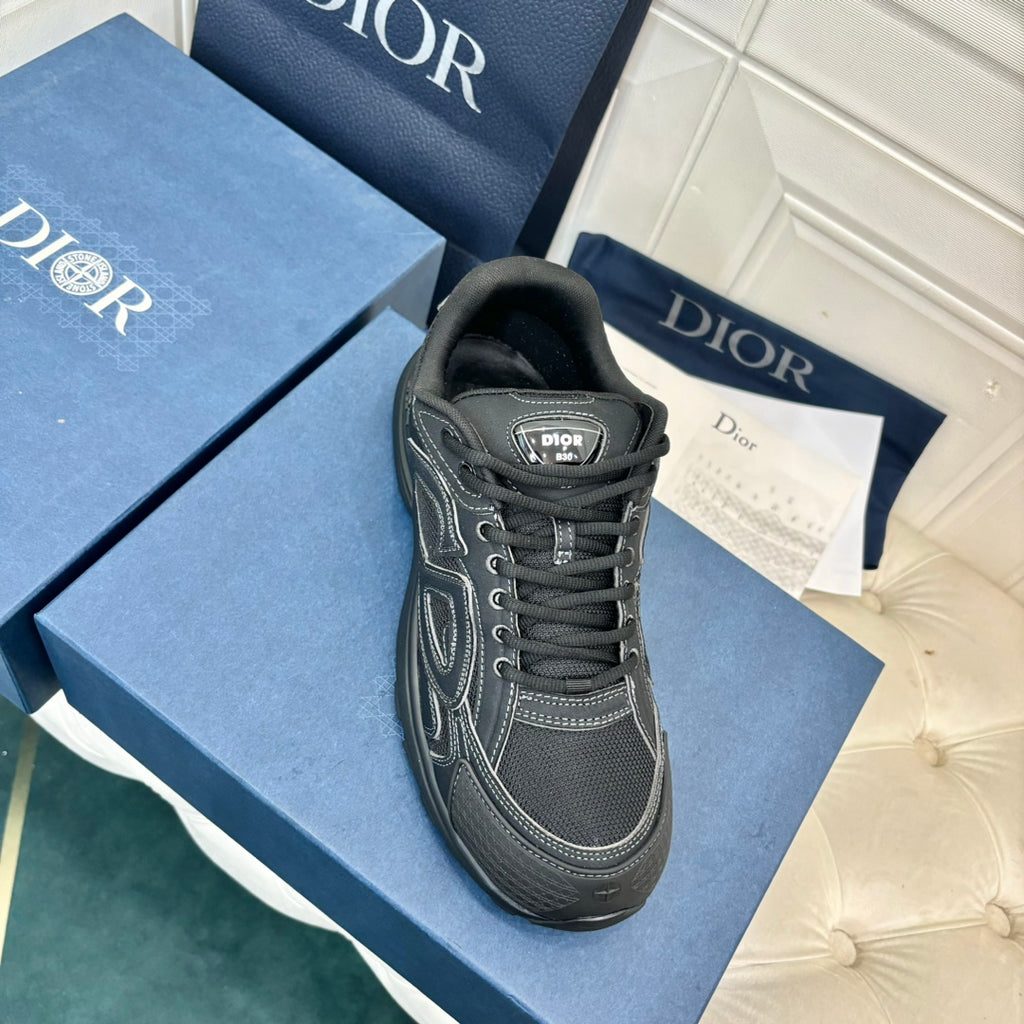 Dior unisex sneaker, dark grey canvas with black laces and side logo patch, angled view