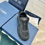 Dior unisex sneaker, dark grey canvas with black laces and side logo patch, angled view