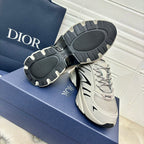 Dior unisex low-top sneakers, light gray with black tread outsole and lace-up front