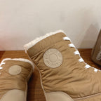 Hermes unisex boot upper detail with circular logo patch, white laces, tan shearling trim.