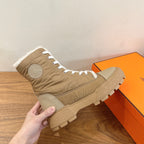 Hermes unisex high-top boot, side view with shearling trim and textured tread outsole.