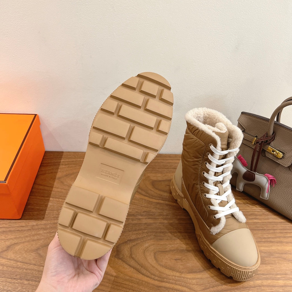 Hermes unisex high-top boot sole view with textured tread and tan boot upper.