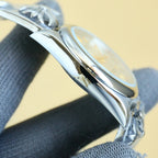 Rolex wristwatch side profile with polished steel case and textured bracelet