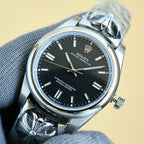 Rolex Oyster Perpetual wristwatch with black dial and steel bracelet