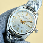 Rolex Oyster Perpetual wristwatch with champagne dial, gold hands, steel case