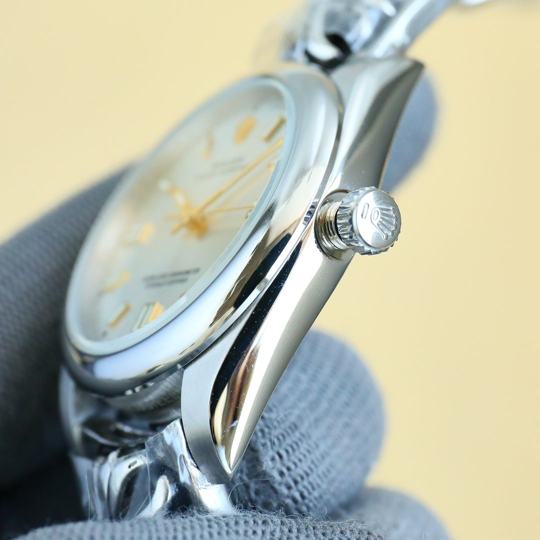 Rolex wristwatch side view with crown and curved polished steel case