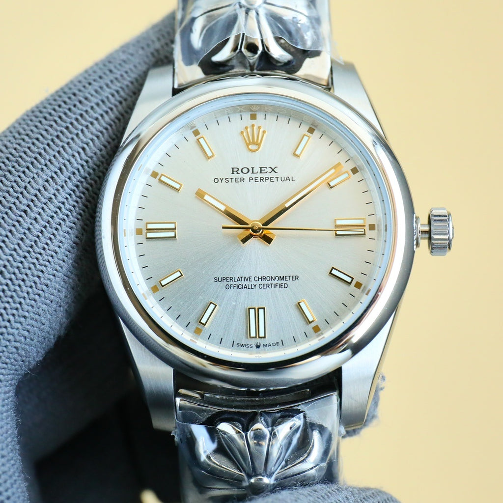 Rolex Oyster Perpetual wristwatch with champagne dial, gold markers, steel bracelet