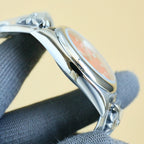 Rolex watch side profile with polished silver case and textured bracelet links