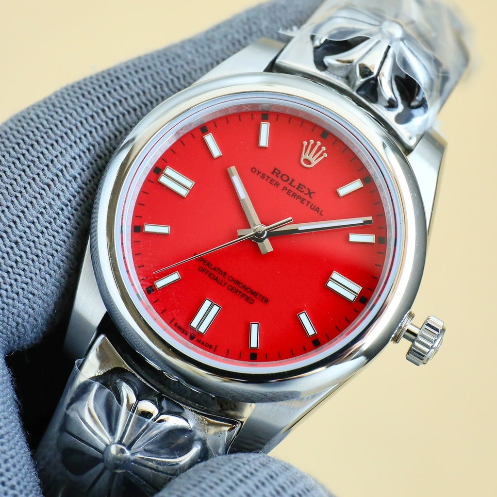Rolex Oyster Perpetual watch with red dial, silver bracelet, crown on the right side