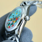 Rolex wristwatch side profile with silver case and crown, turquoise dial with colorful motifs