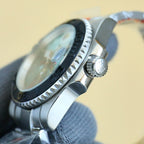 Rolex stainless steel wristwatch side profile with crown and black bezel edge detail.