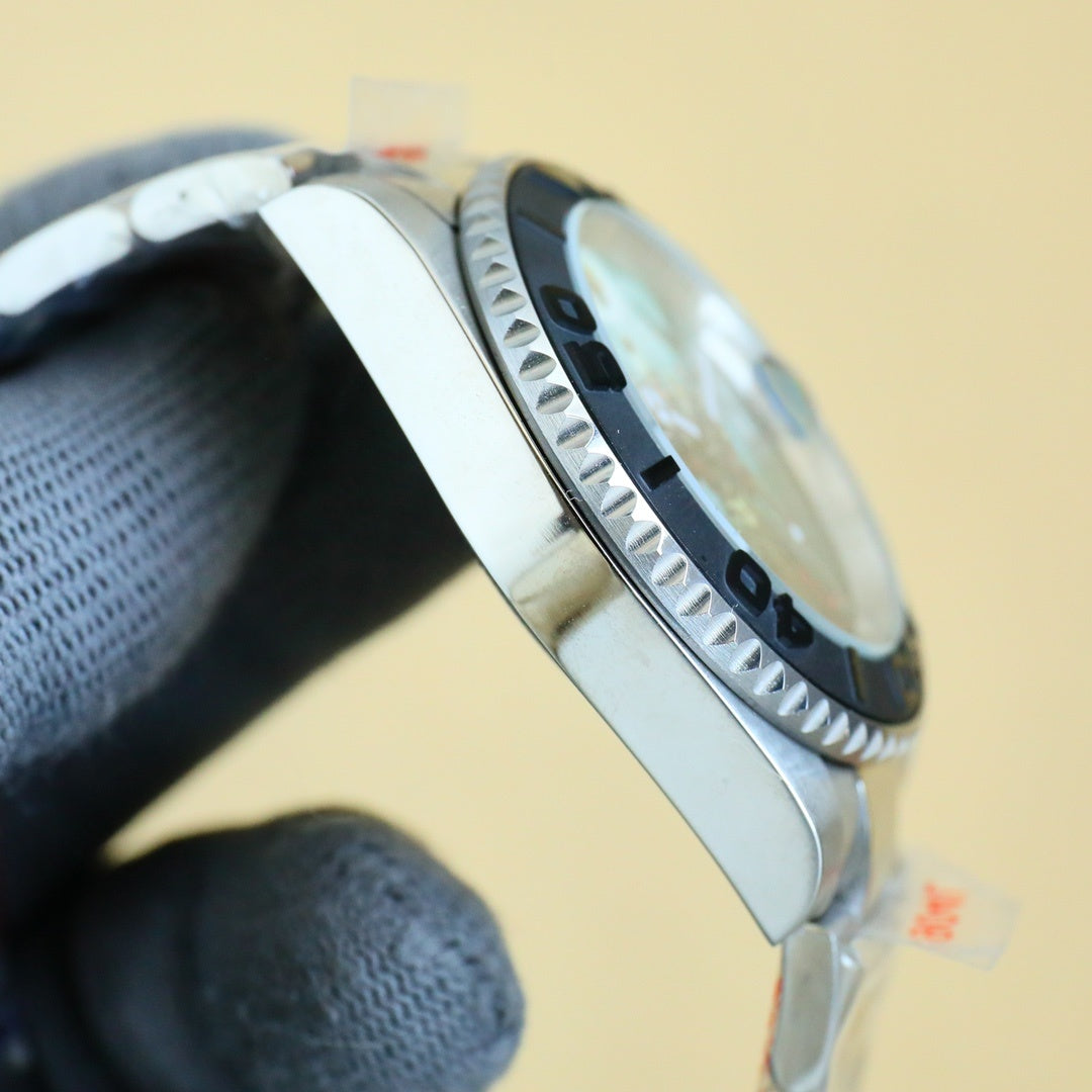 Rolex stainless steel wristwatch side view with black bezel and textured minute markers.