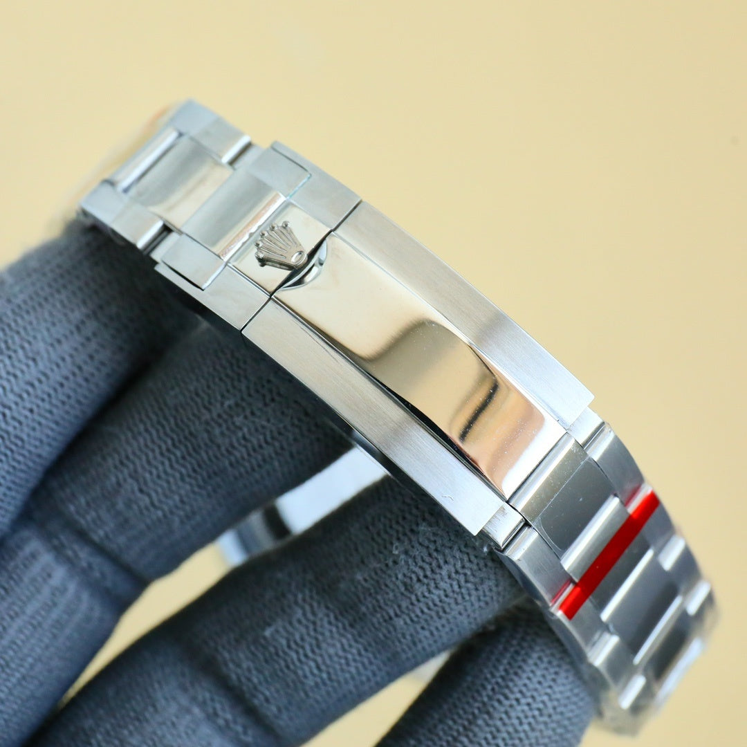 Rolex stainless steel watch bracelet clasp with red accent and folded link.