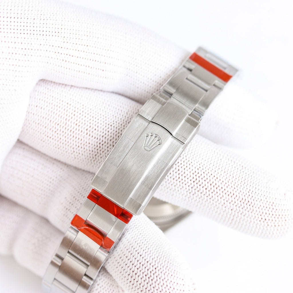 Stainless-steel watch bracelet with clasp and orange accent plate on underside