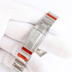 Stainless-steel watch bracelet with clasp and orange accent plate on underside