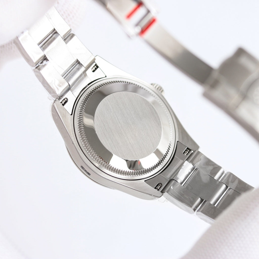 Rolex watch caseback with brushed silver finish and ridged bezel on bracelet