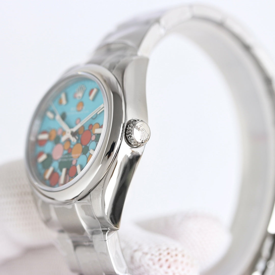 Rolex watch side profile with turquoise dial and crown on silver metal bracelet