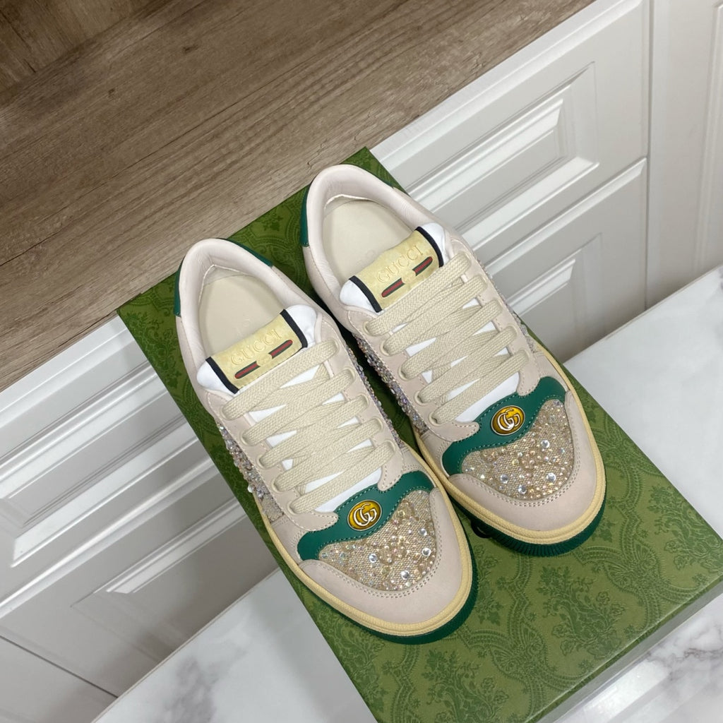 Gucci lace-up sneakers with cream canvas, green heel details, and glitter toe patches