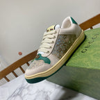 Gucci low-top sneakers featuring cream leather, green trim, and glittered side panel