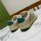 Gucci sneakers with cream uppers, green heel tabs, and rhinestone sparkle on the toe