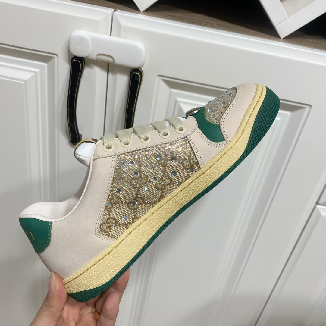 Gucci sneakers on a white door: cream leather, green side stripe, and sparkling front