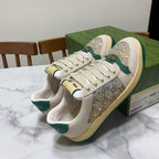 Gucci unisex sneakers pair shown at an angle: cream uppers with green accents and glitter