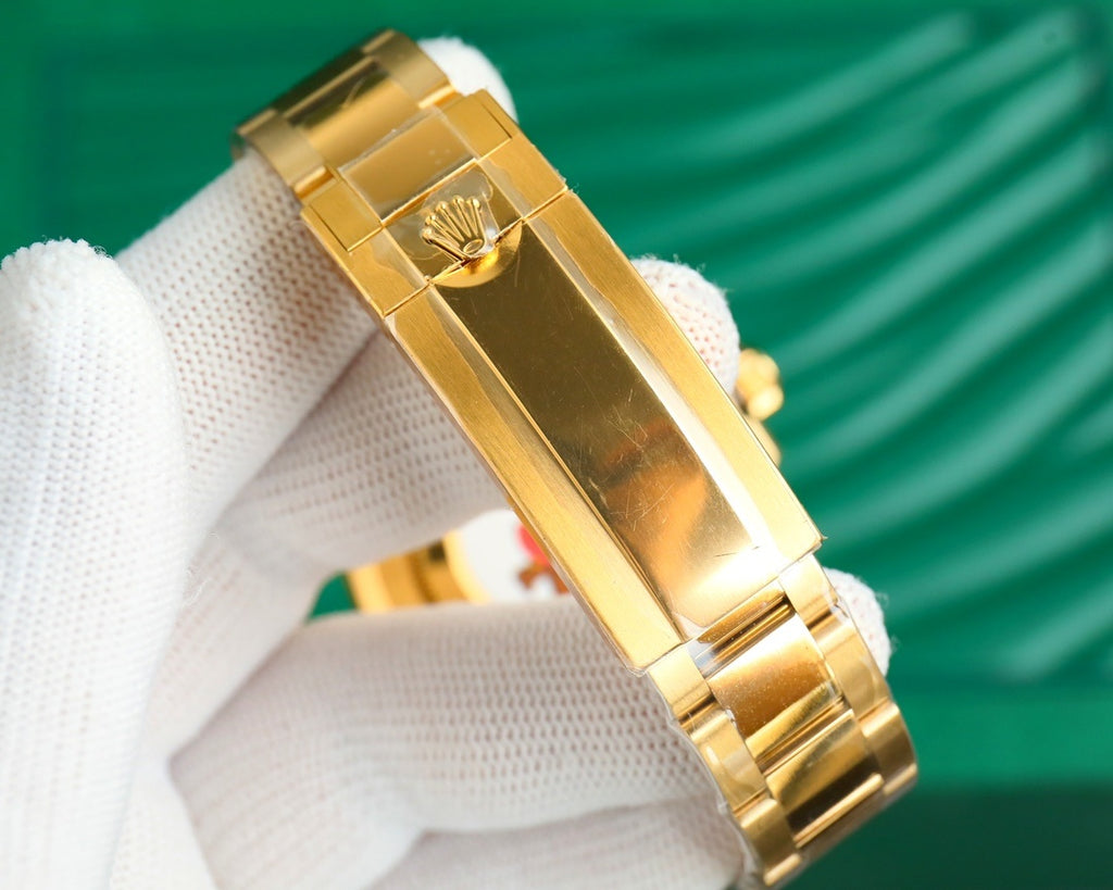 Gold-tone watch bracelet and case side with crown on a white glove