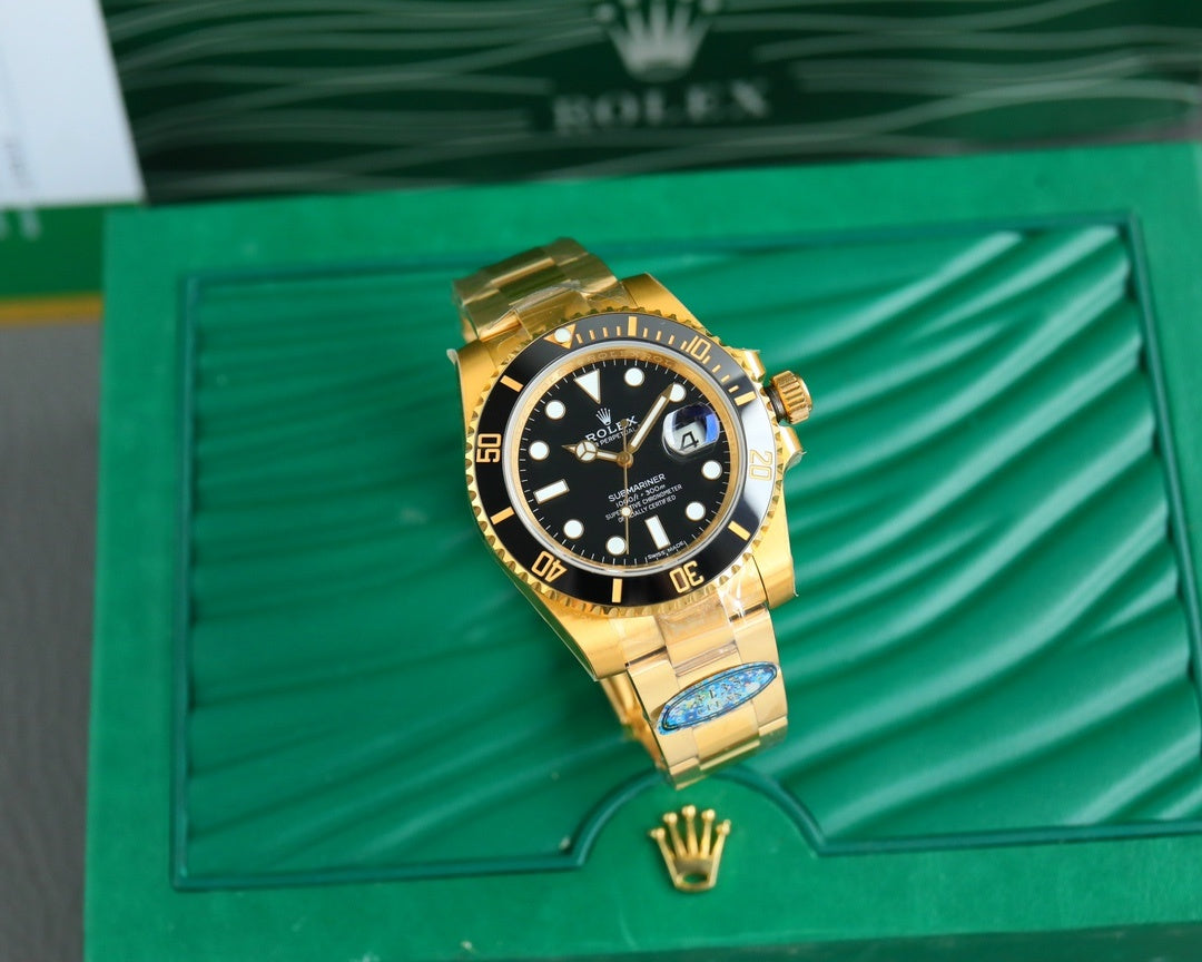 Gold-tone wristwatch with black dial and gold bezel on a green box