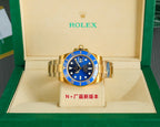 Rolex gold watch with blue dial and jubilee-style bracelet, shown in gift box
