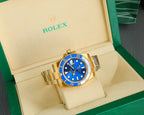 Rolex gold watch with blue dial and bracelet, in open display box