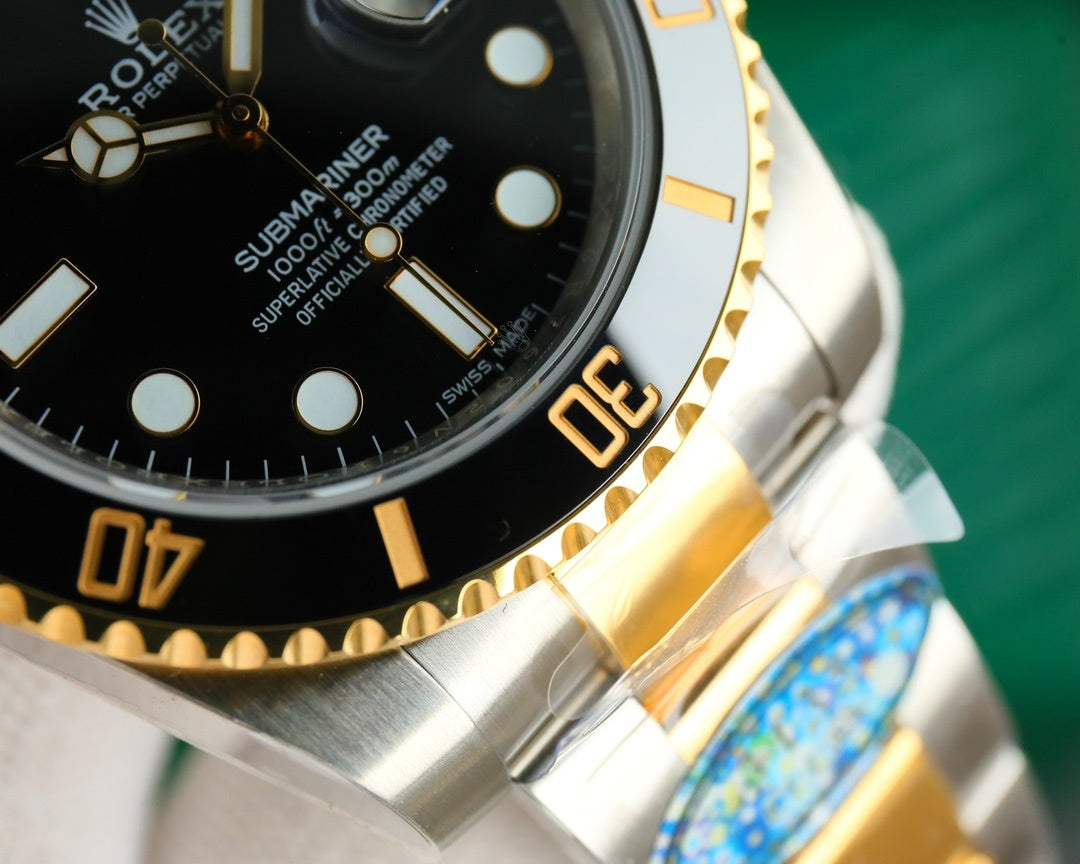 Rolex watch bezel close-up with gold indices and two-tone metal bracelet links