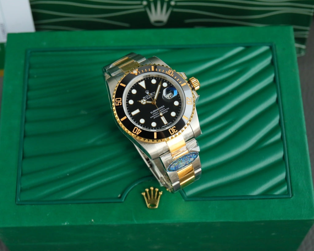 Rolex watch full view in presentation box, black dial with gold bezel and two-tone bracelet