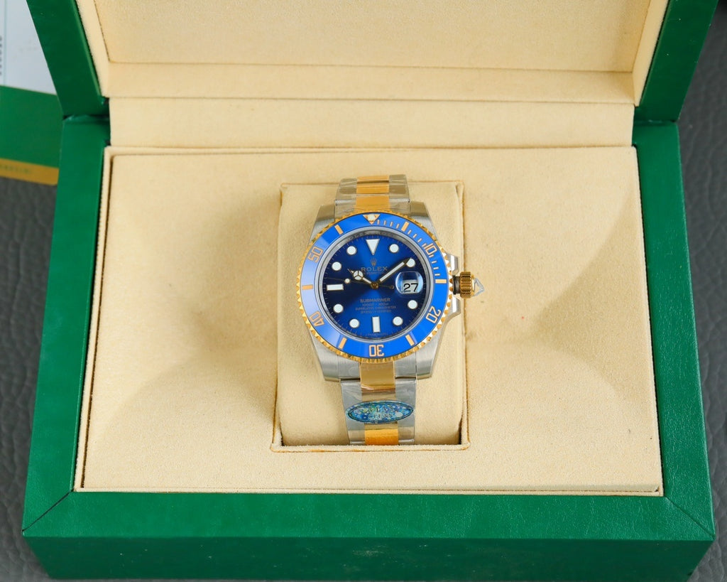 Rolex watch in display box, blue dial and gold bezel with steel-and-gold bracelet