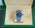 Stainless steel wristwatch with blue dial and bezel, displayed in cream box