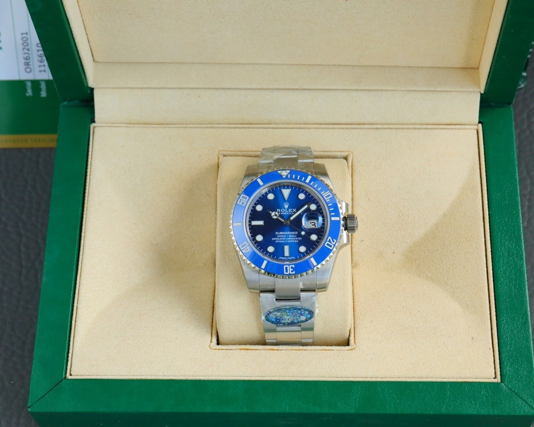 Stainless steel wristwatch with blue dial and bezel, displayed in cream box