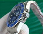 Stainless steel wristwatch with blue bezel and crown, angled close-up