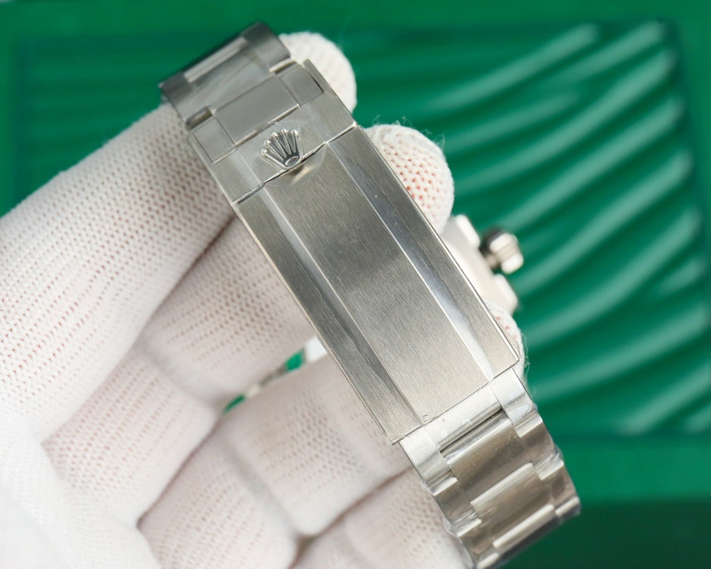 Rolex watch in stainless steel with crown detail and bracelet links, close-up view