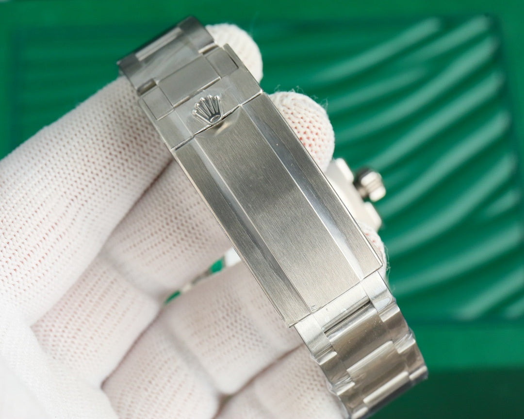 Rolex watch in stainless steel with crown detail and bracelet links, close-up view