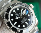 Rolex watch with black dial and stainless steel case, close-up of watch face