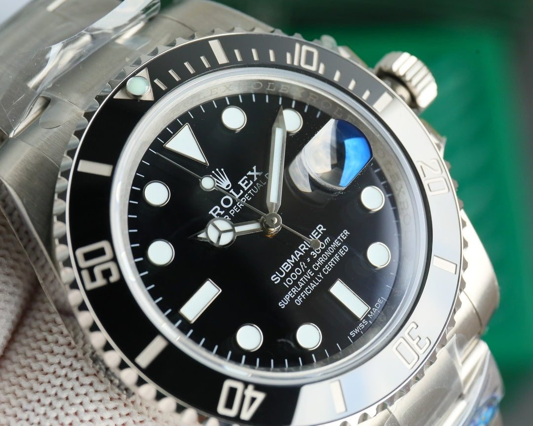 Rolex watch with black dial and stainless steel case, close-up of watch face