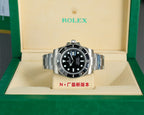 Rolex watch with black dial, black bezel, and stainless steel bracelet on display box