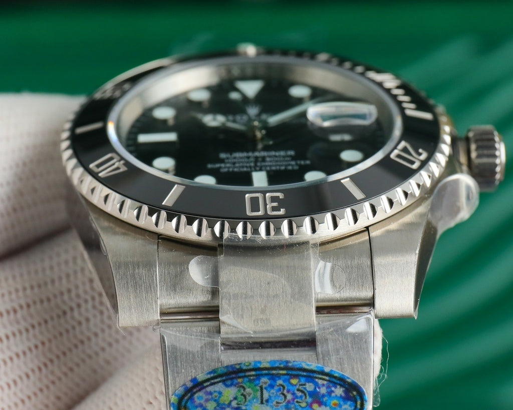 Rolex watch with black bezel and stainless steel case, side view