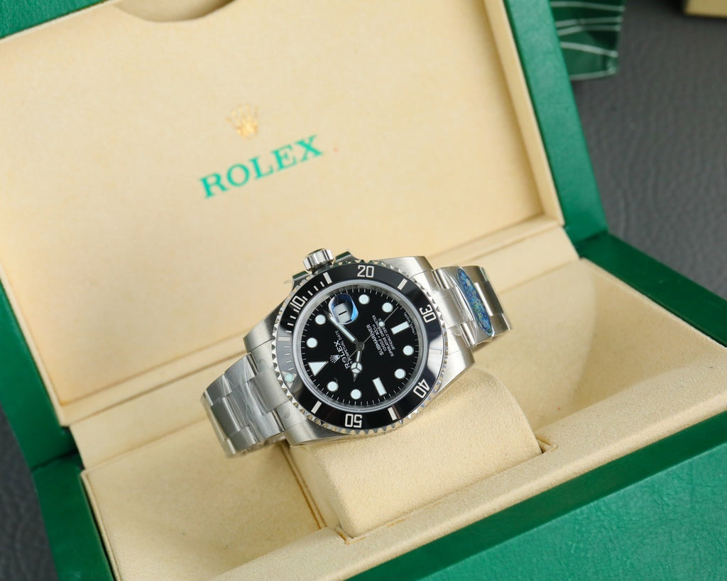 Rolex watch with black dial and black bezel, stainless steel bracelet in display box