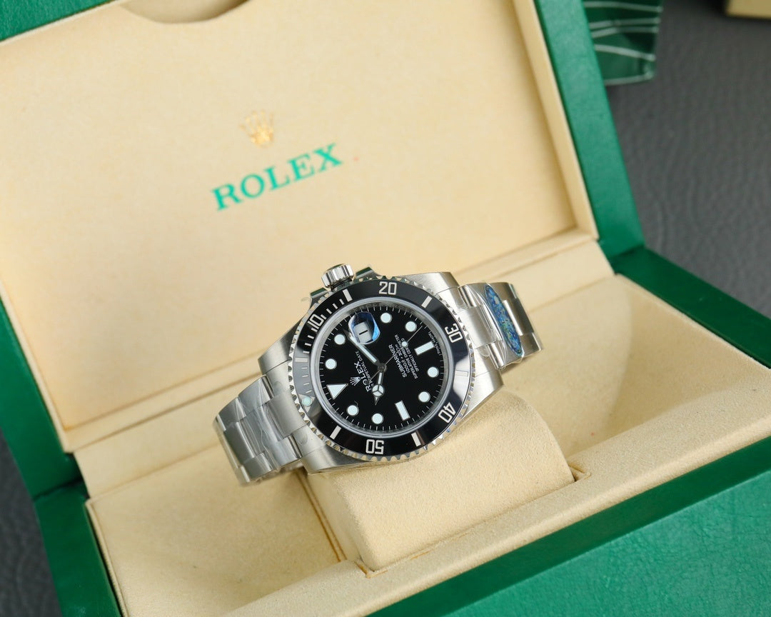 Rolex watch with black dial and black bezel, stainless steel bracelet in display box