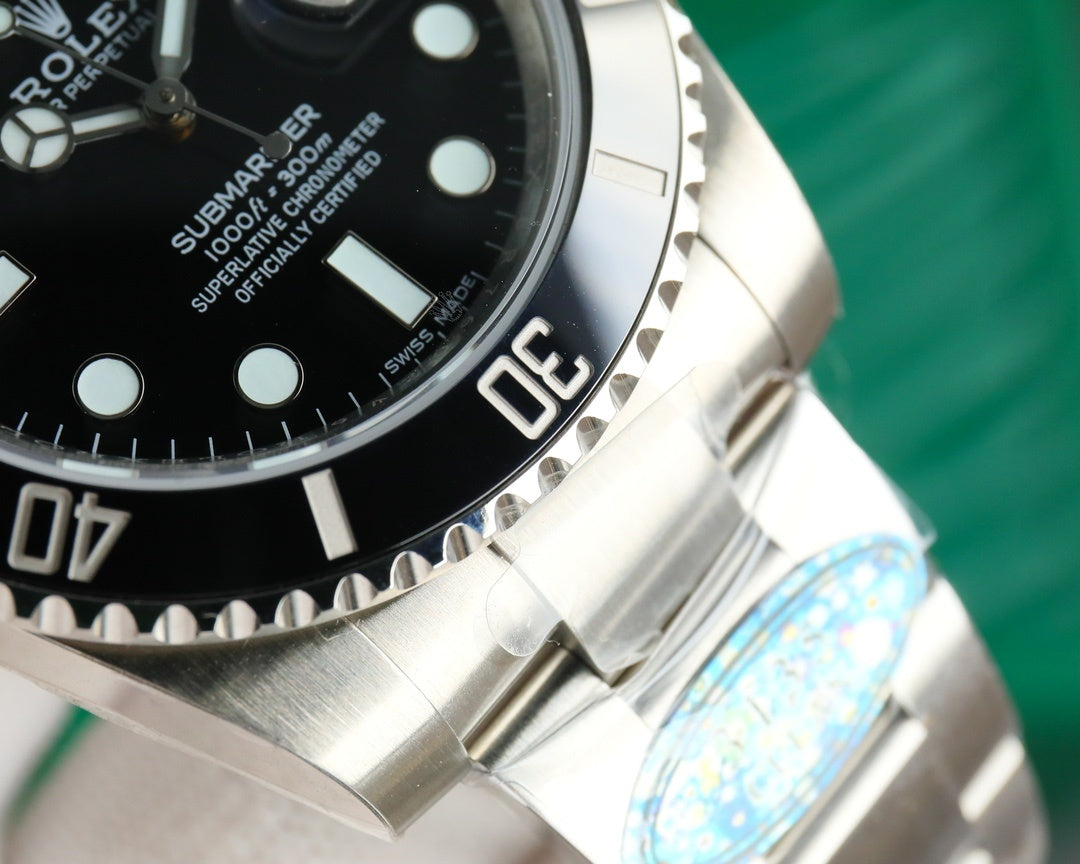 Rolex watch bezel detail with “Submariner” text and stainless steel case
