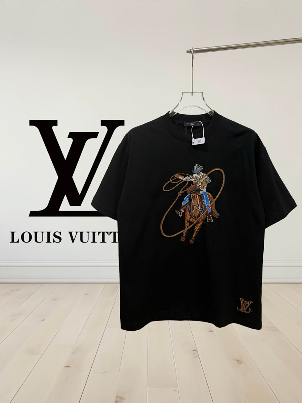 Black crewneck T-shirt with colorful embroidered rider graphic on chest